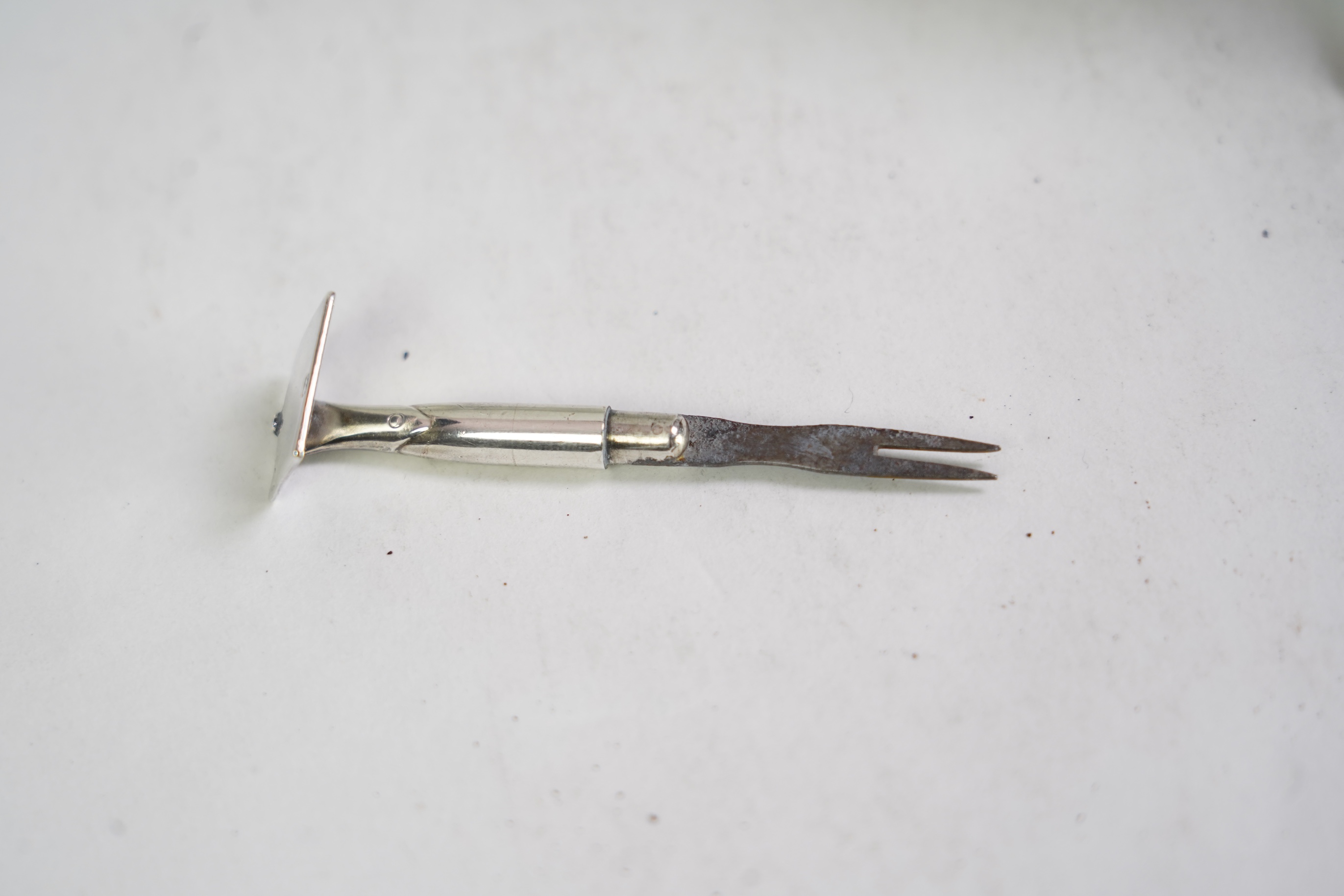 A rare Victorian novelty silver smoker's compendium set, modelled as an upturned straw hat with gardening tools tripod support, by Jane Brownett